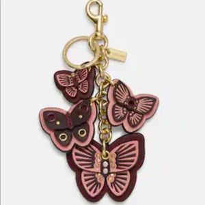 NWT coach butterfly cluster , boysenberry color